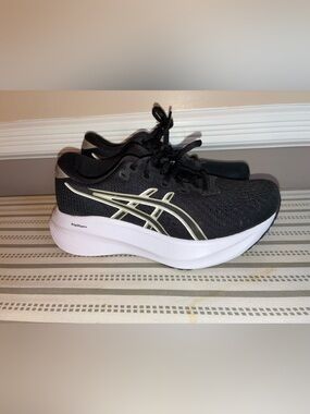 ASICS Black Sneakers with White Sole and Gold Accent